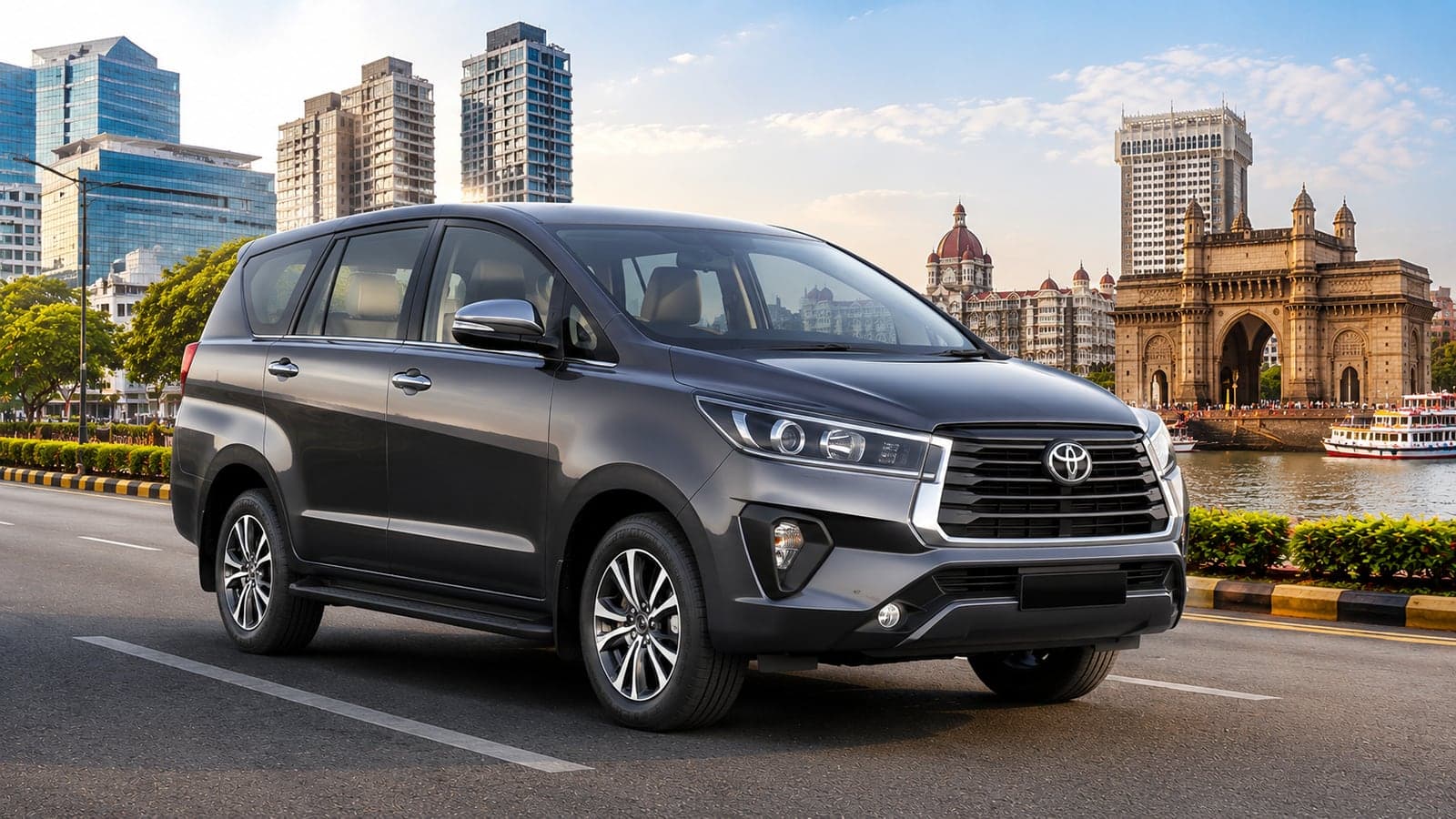 Grey Toyota Innova Crysta on a waterfront road beside the Gateway of India in Mumbai