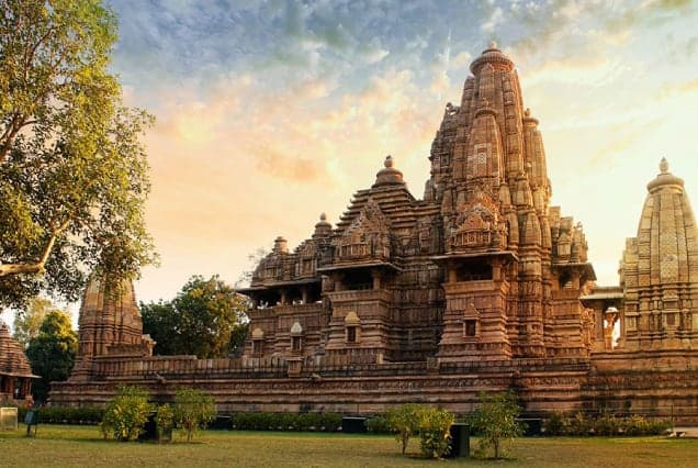 The carved sandstone spires of a Khajuraho temple at sunset