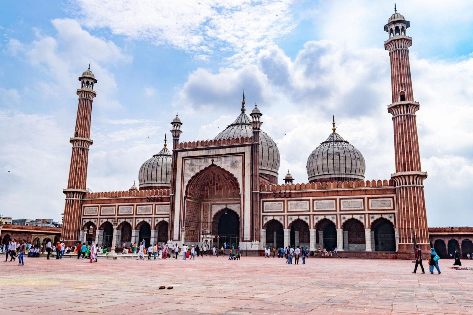 The red sandstone and marble Jama Masjid in Old Delhi, with visitors in its courtyard